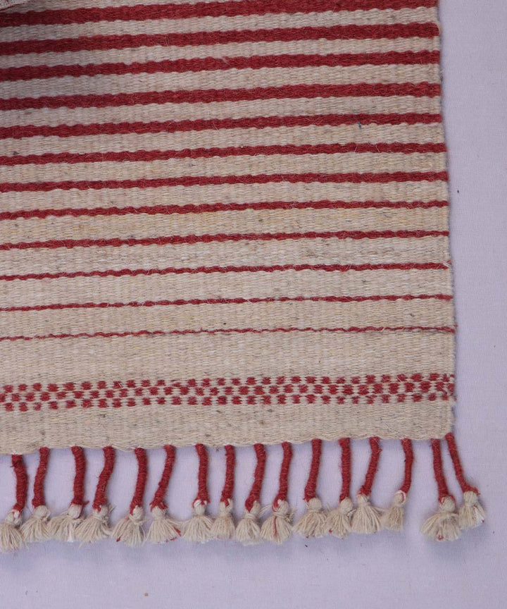 Red white handwoven woolen carpet