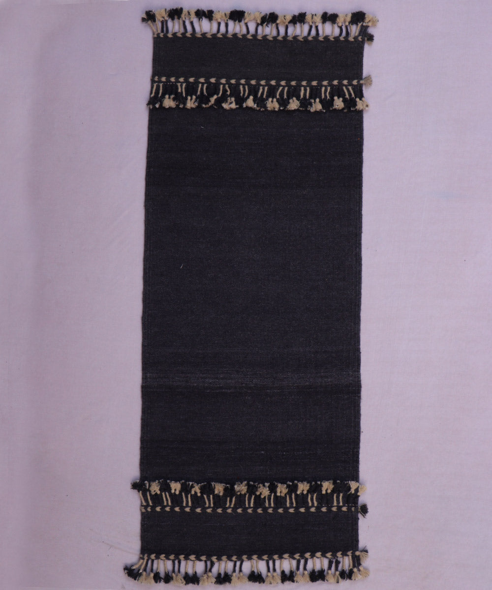 Black handwoven woolen carpet