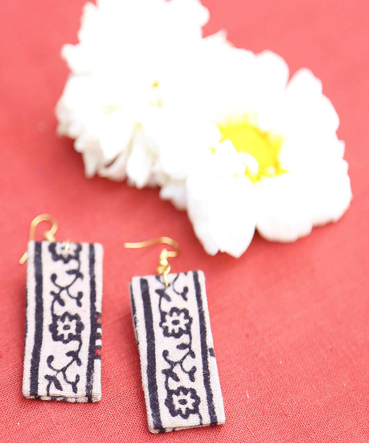 creme black floral border earrings